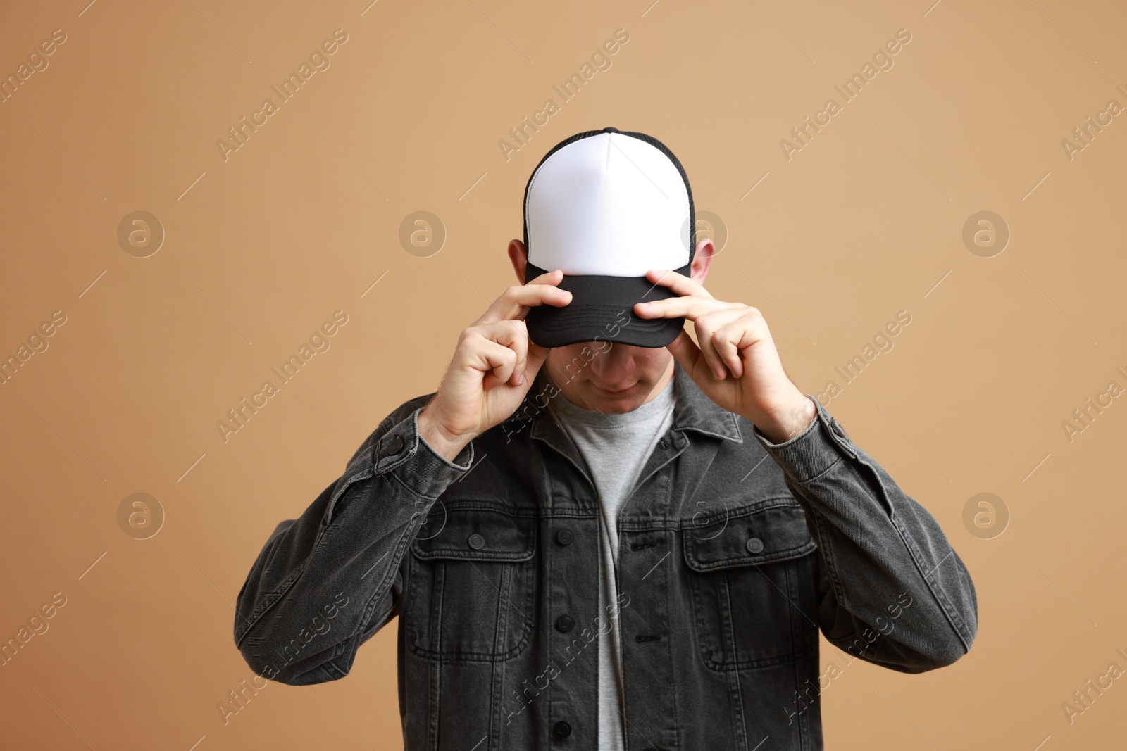 Photo of Man in stylish baseball cap on beige background. Mockup for design