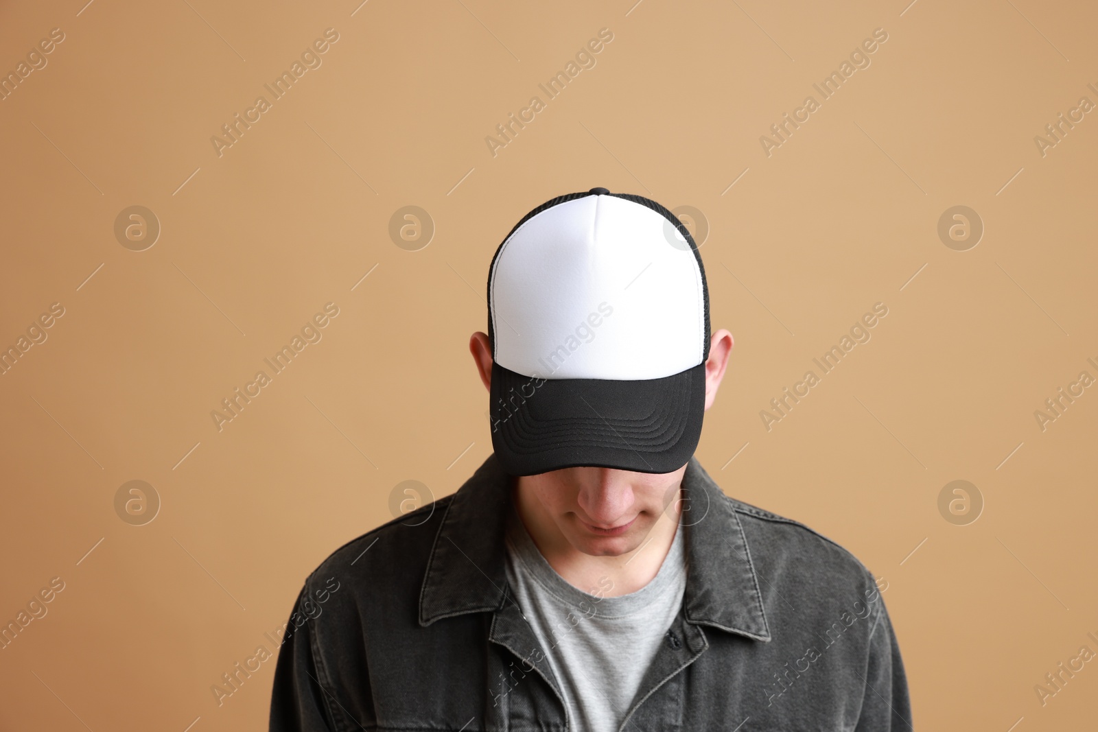 Photo of Man in stylish baseball cap on beige background. Mockup for design