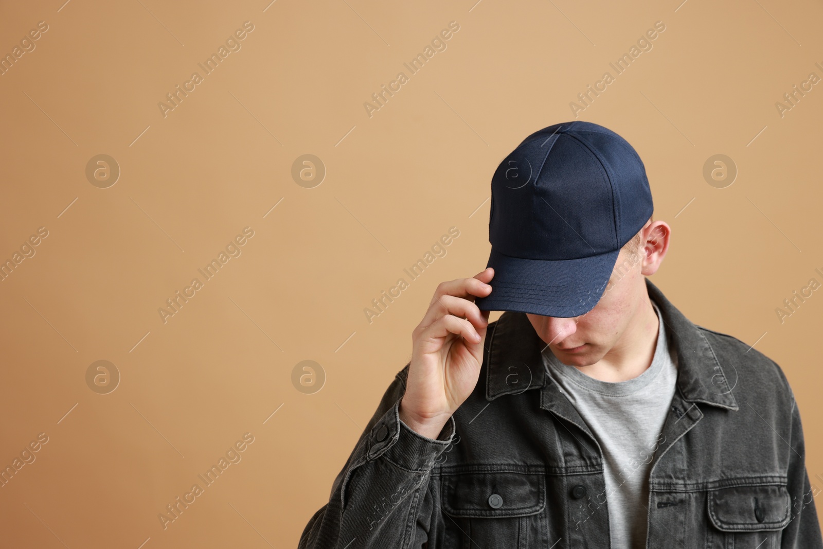 Photo of Man in stylish baseball cap on beige background. Mockup for design