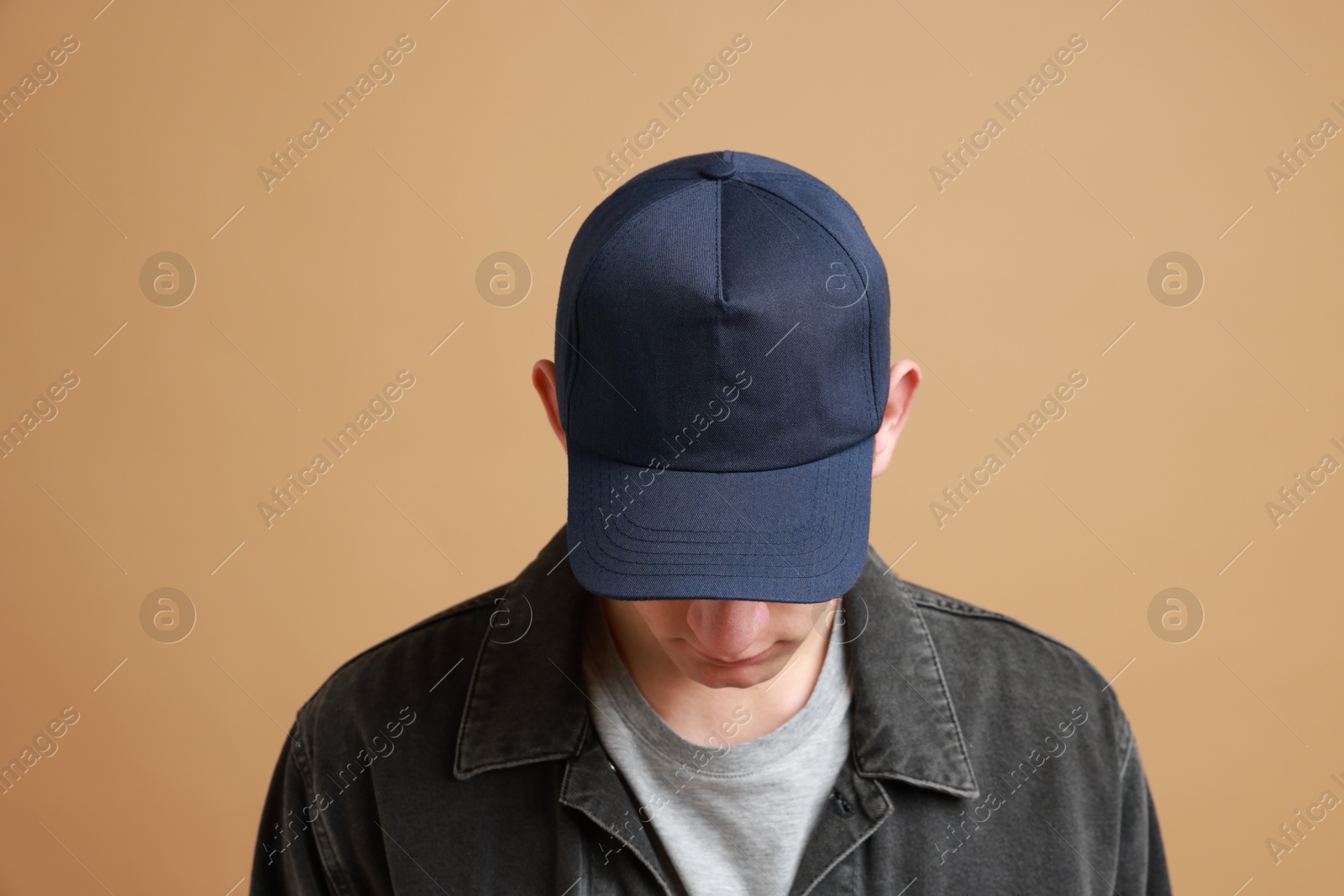 Photo of Man in stylish baseball cap on beige background. Mockup for design