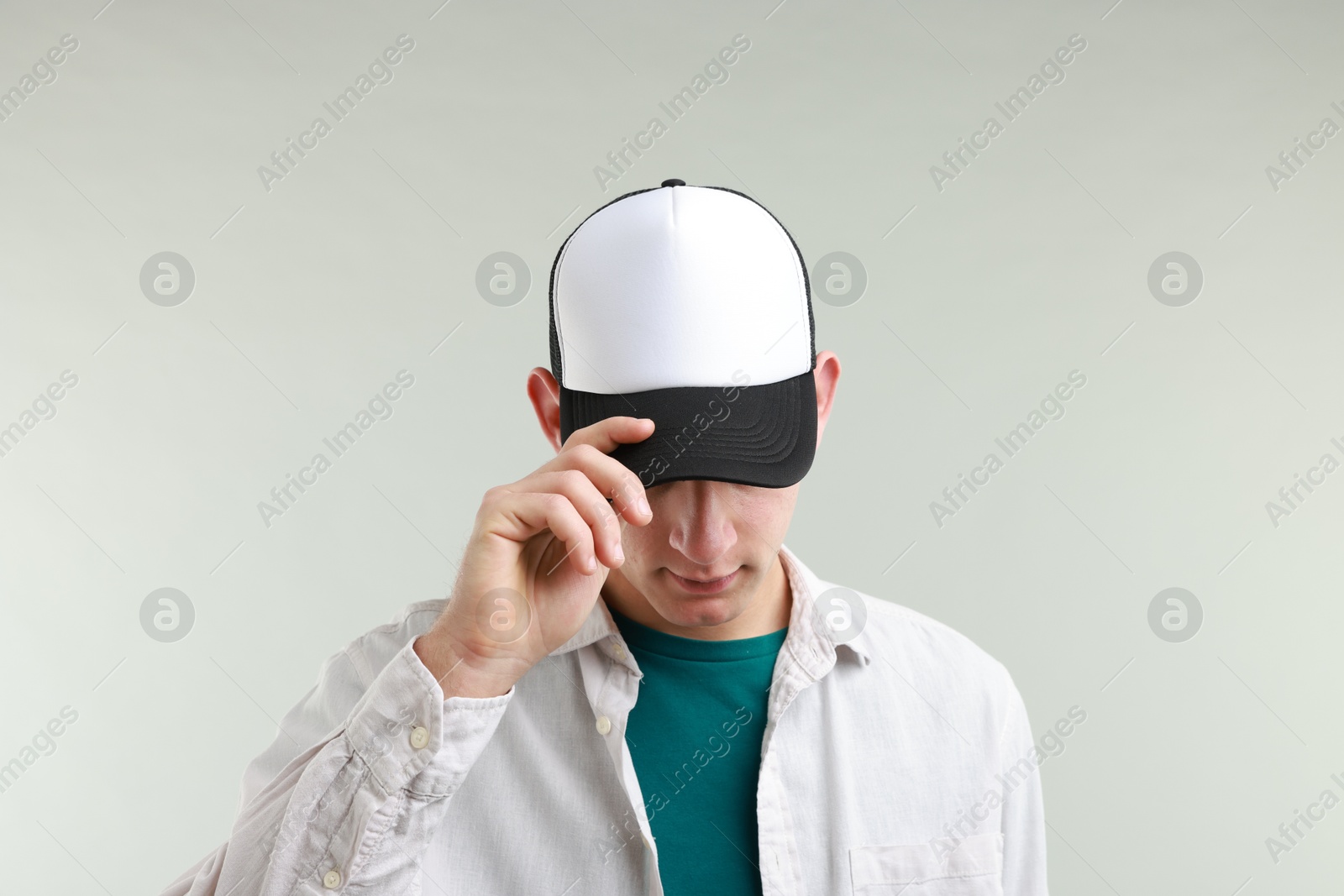 Photo of Man in stylish baseball cap on light grey background. Mockup for design