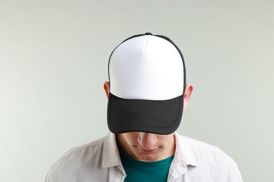 Photo of Man in stylish baseball cap on light grey background. Mockup for design