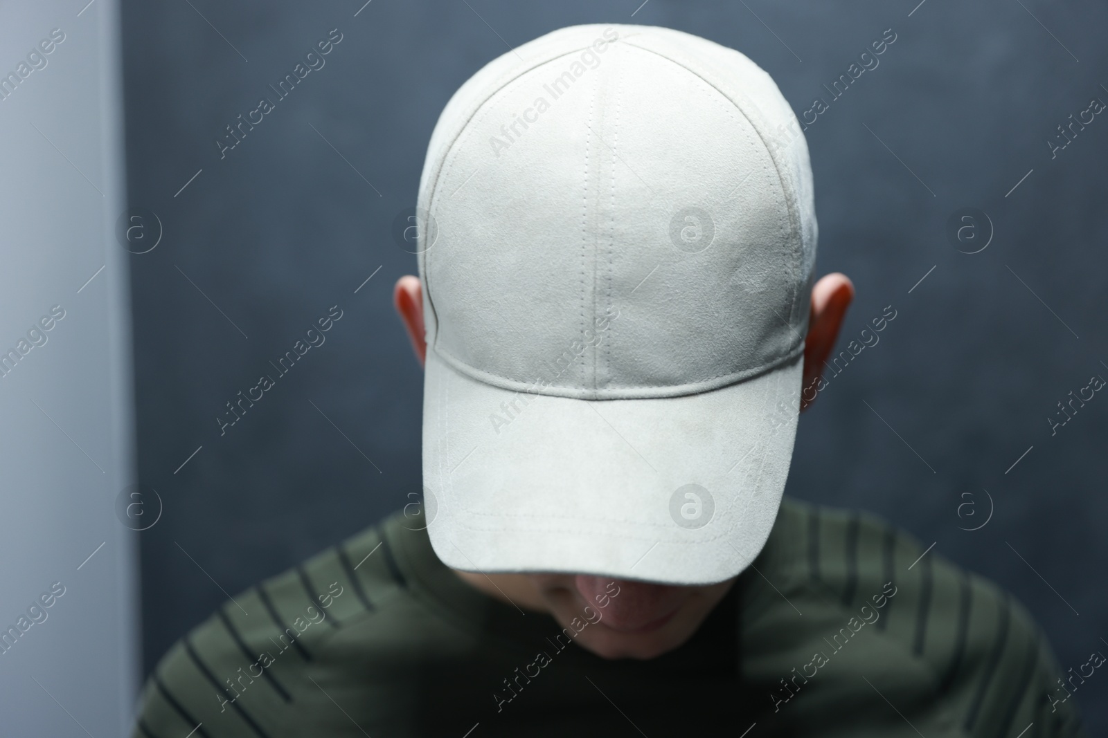 Photo of Man in stylish baseball cap on blurred background. Mockup for design