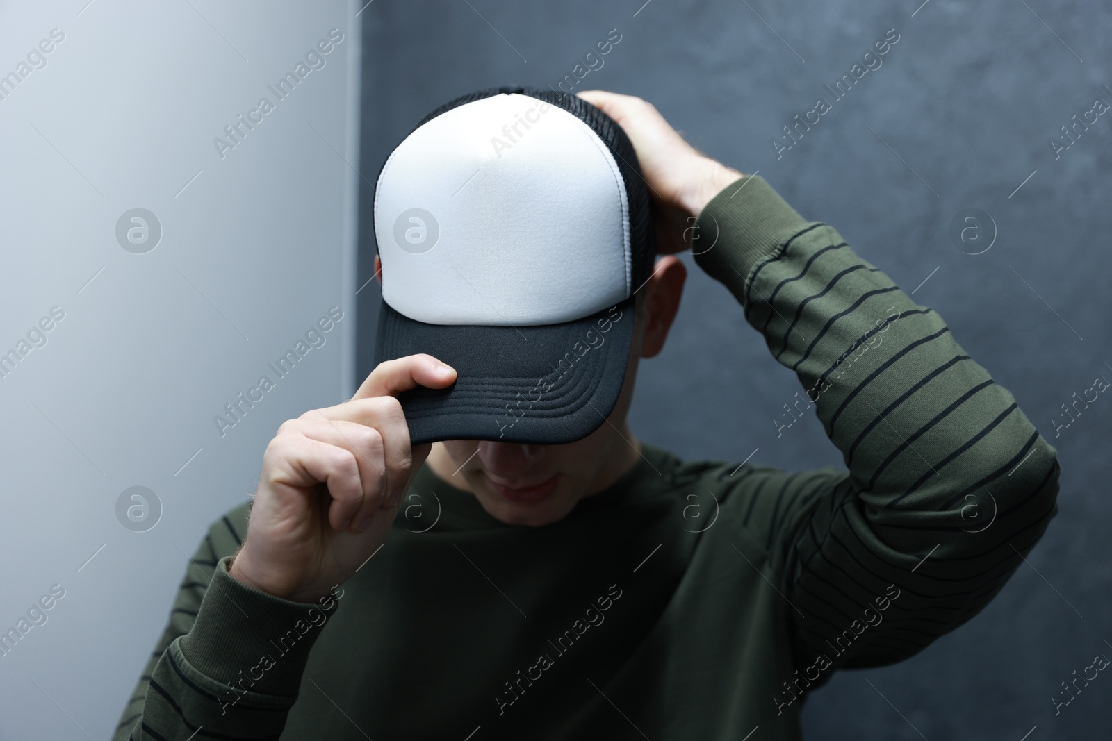 Photo of Man in stylish baseball cap on blurred background. Mockup for design