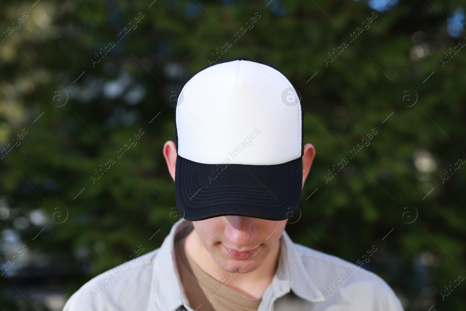 Photo of Man in stylish baseball cap outdoors. Mockup for design