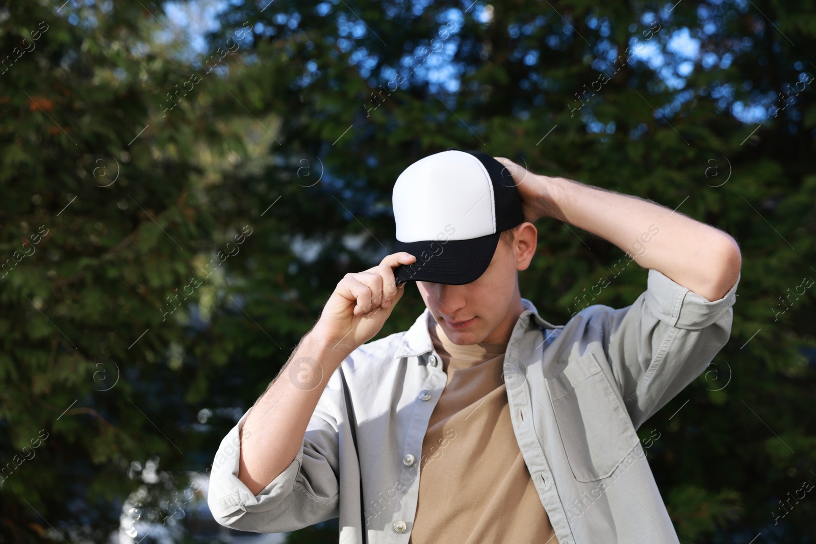 Photo of Man in stylish baseball cap outdoors. Mockup for design