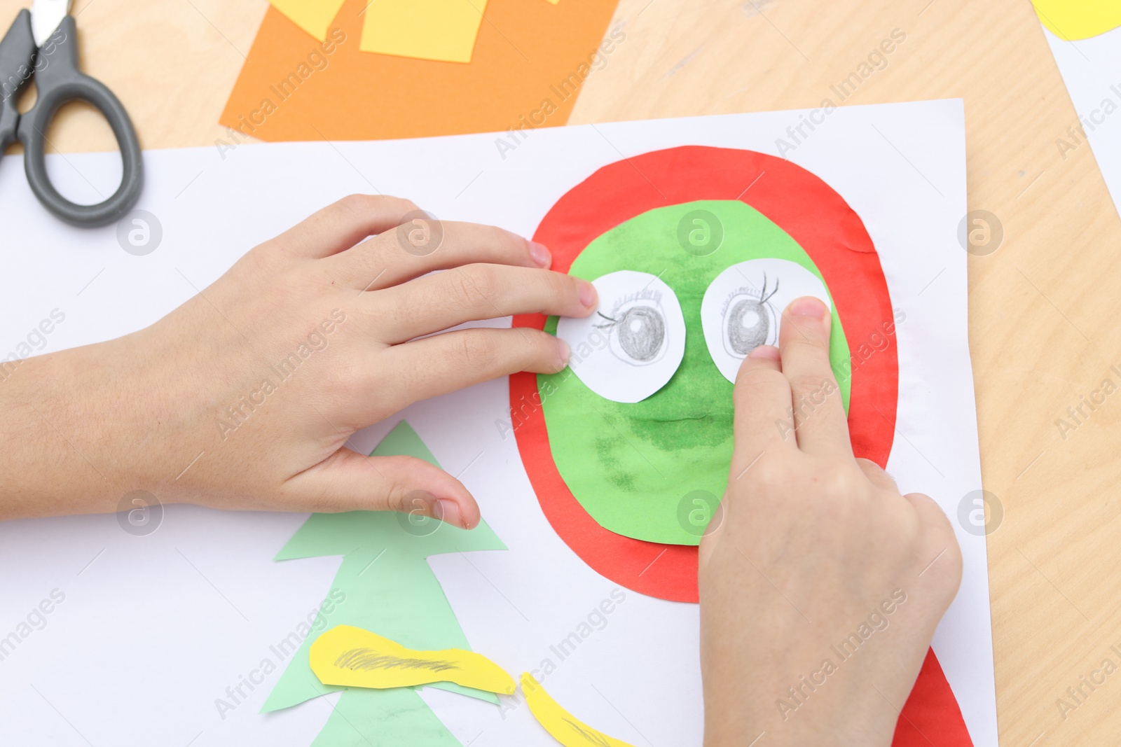 Photo of Girl making art project at table indoors, above view