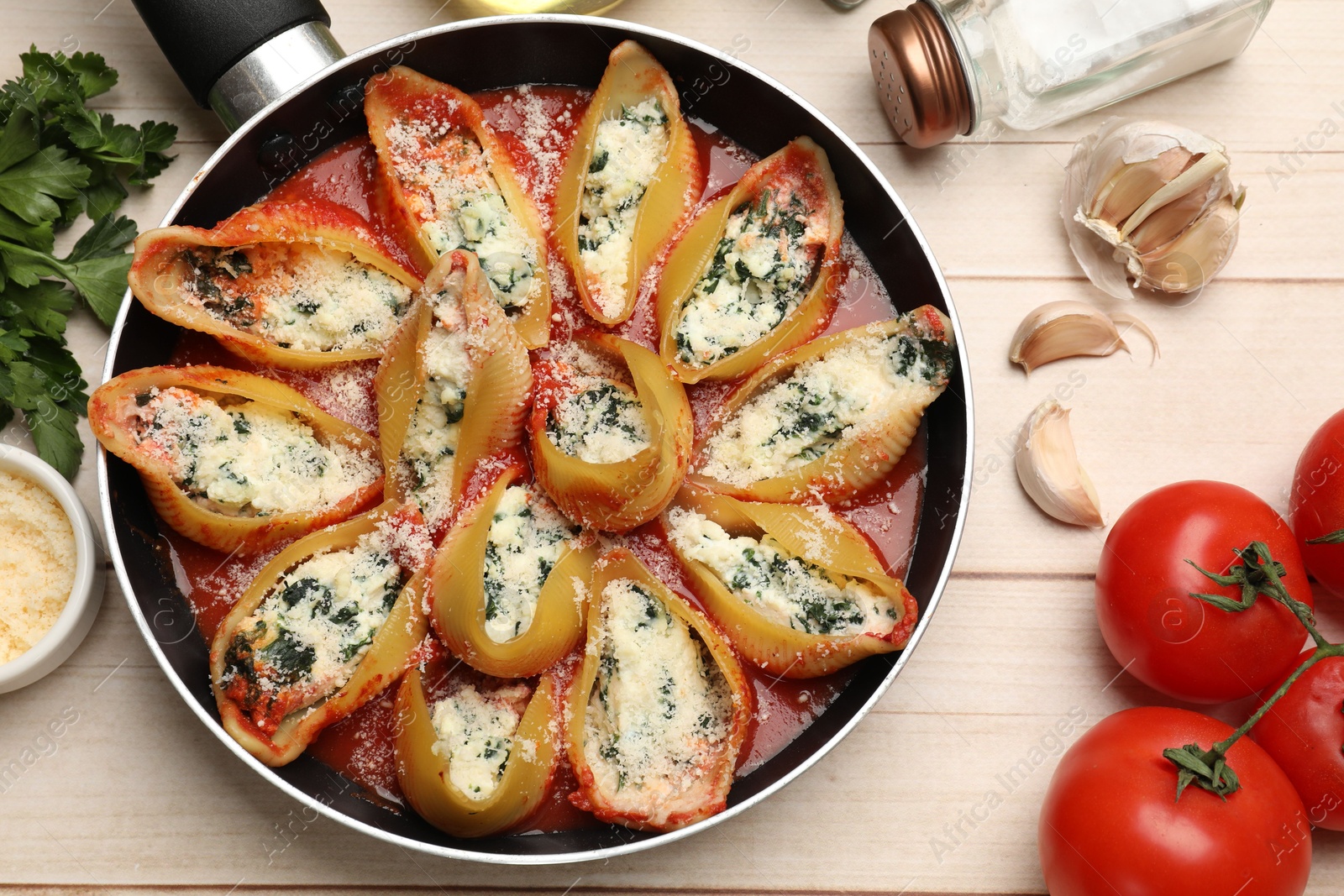 Photo of Delicious shell pasta stuffed with ricotta and spinach served on white wooden table, flat lay