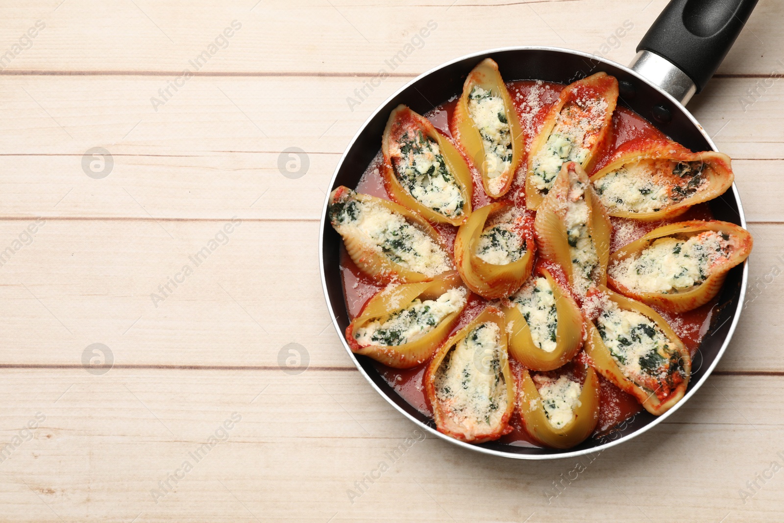 Photo of Delicious shell pasta stuffed with ricotta and spinach on white wooden table, top view. Space for text