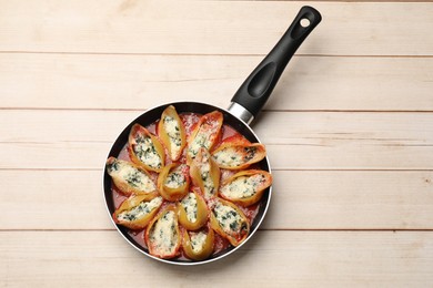 Photo of Delicious shell pasta stuffed with ricotta and spinach on white wooden table, top view