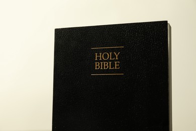 Hardcover Holy Bible in English language on light background, closeup