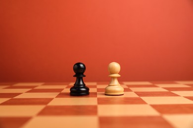 Photo of Black and white pawns in middle of chessboard. Competition concept