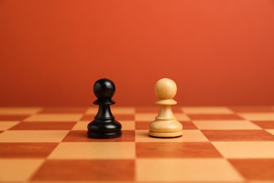 Photo of Black and white pawns in middle of chessboard. Competition concept