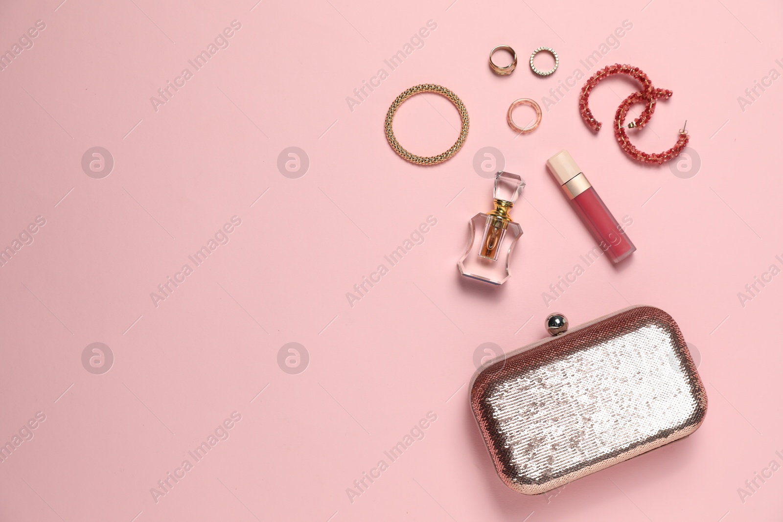 Photo of Many stylish jewelry and accessories on pink background, flat lay. Space for text