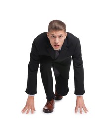 Businessman in starting position for run ready for competition on white background