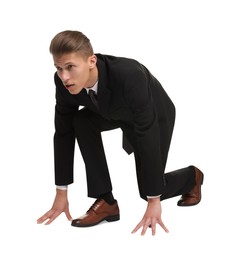 Photo of Businessman in starting position for run ready for competition on white background