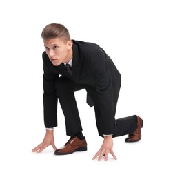 Photo of Businessman in starting position for run ready for competition on white background