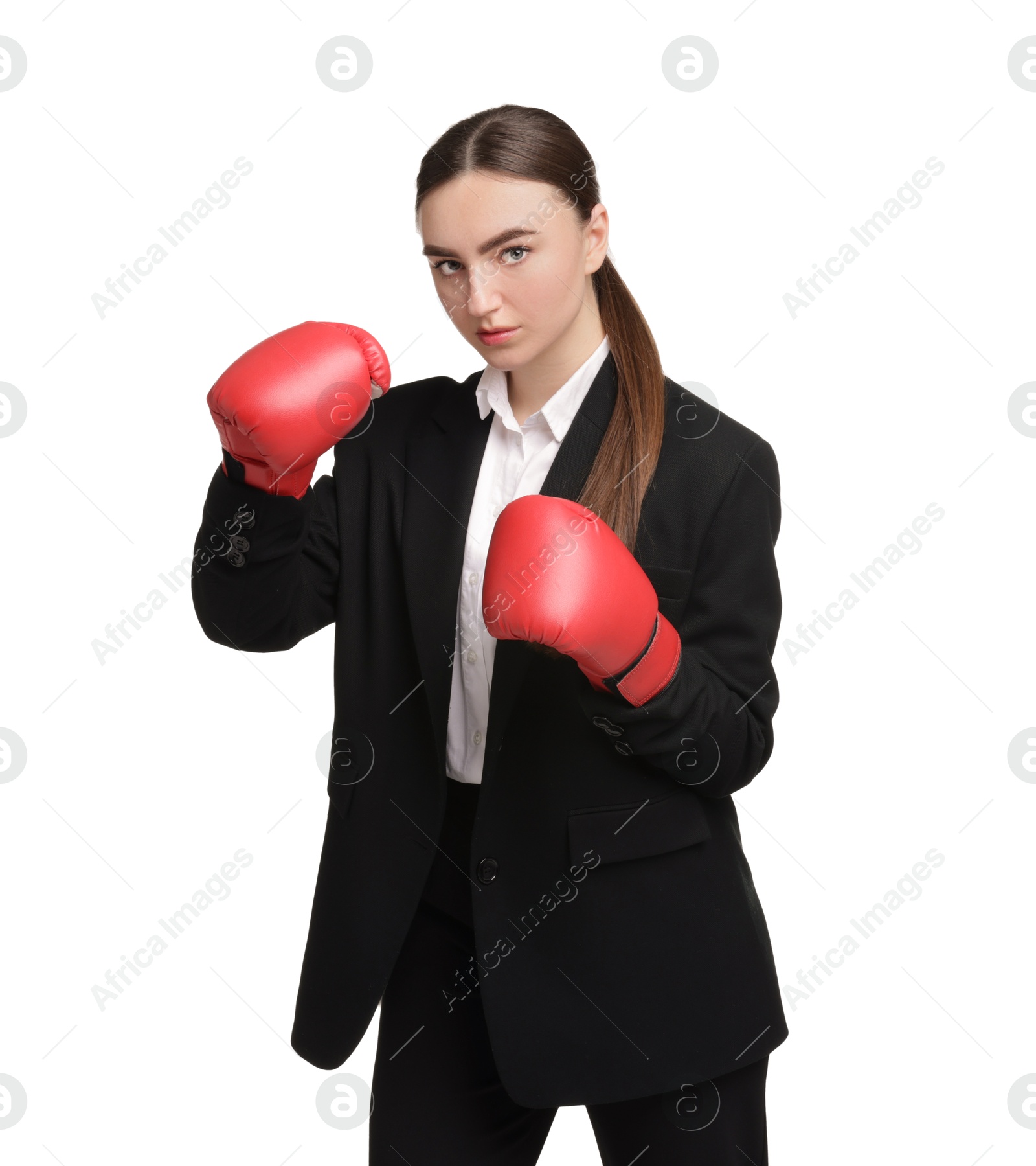 Photo of Competition. Businesswoman in suit wearing boxing gloves on white background