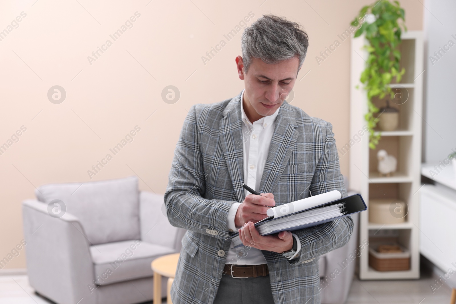 Photo of Real estate appraisal. Inspector with clipboard conducting property valuation at home. Space for text