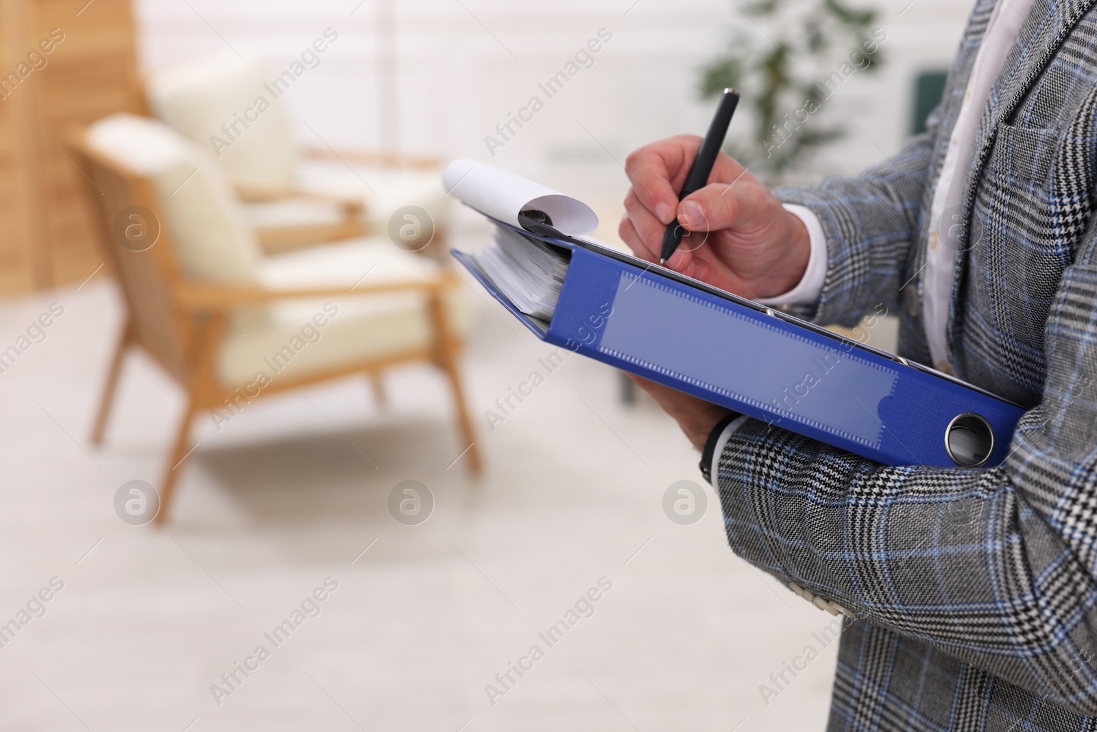 Photo of Real estate appraisal. Inspector with clipboard conducting property valuation at home, closeup. Space for text