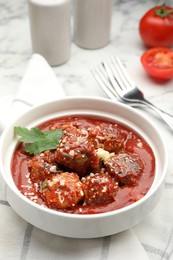 Photo of Delicious meatballs with tomato sauce, parmesan cheese and parsley served on white marble table, closeup