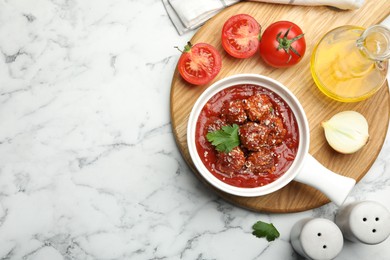 Photo of Delicious meatballs with tomato sauce, parmesan cheese and parsley served on white marble table, flat lay. Space for text