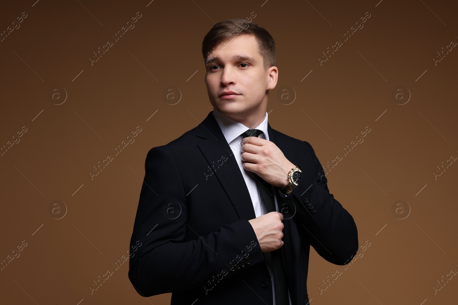 Photo of Man in classic suit on brown background