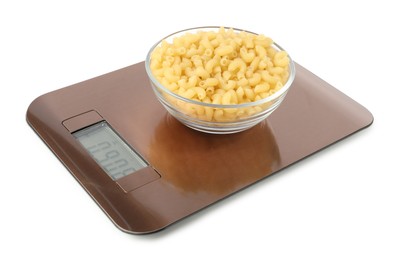 Photo of Electronic kitchen scale with bowl of raw pasta isolated on white