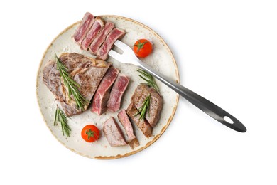 Photo of Pieces of delicious beef meat, spices, tomatoes and carving fork isolated on white, top view