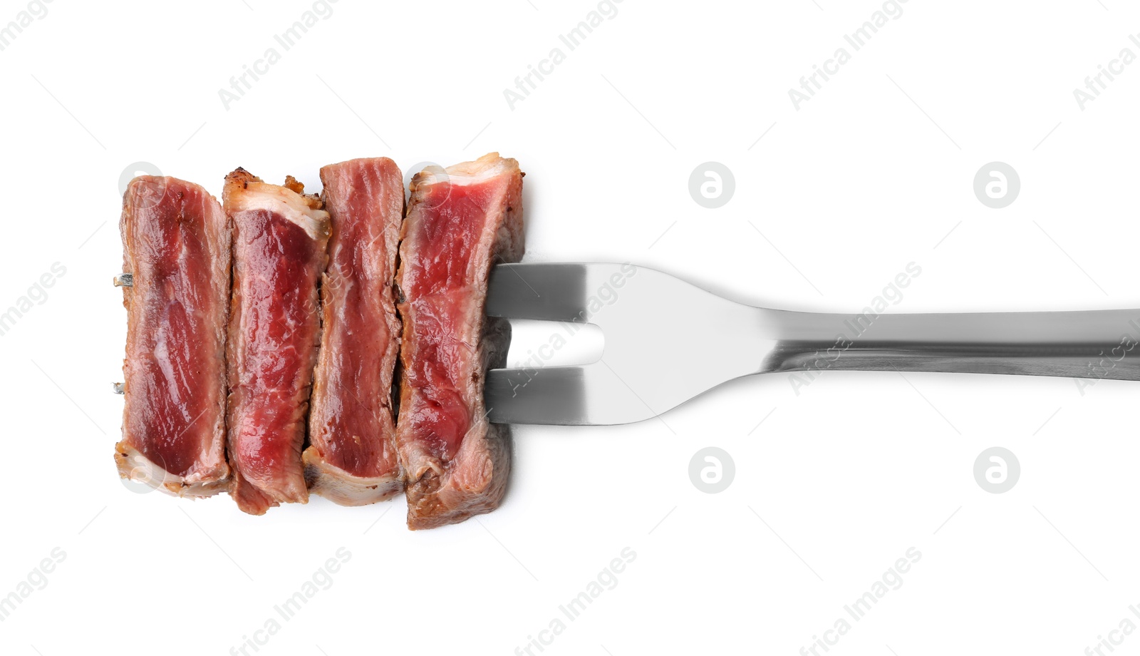 Photo of Carving fork with pieces of delicious beef meat isolated on white, top view