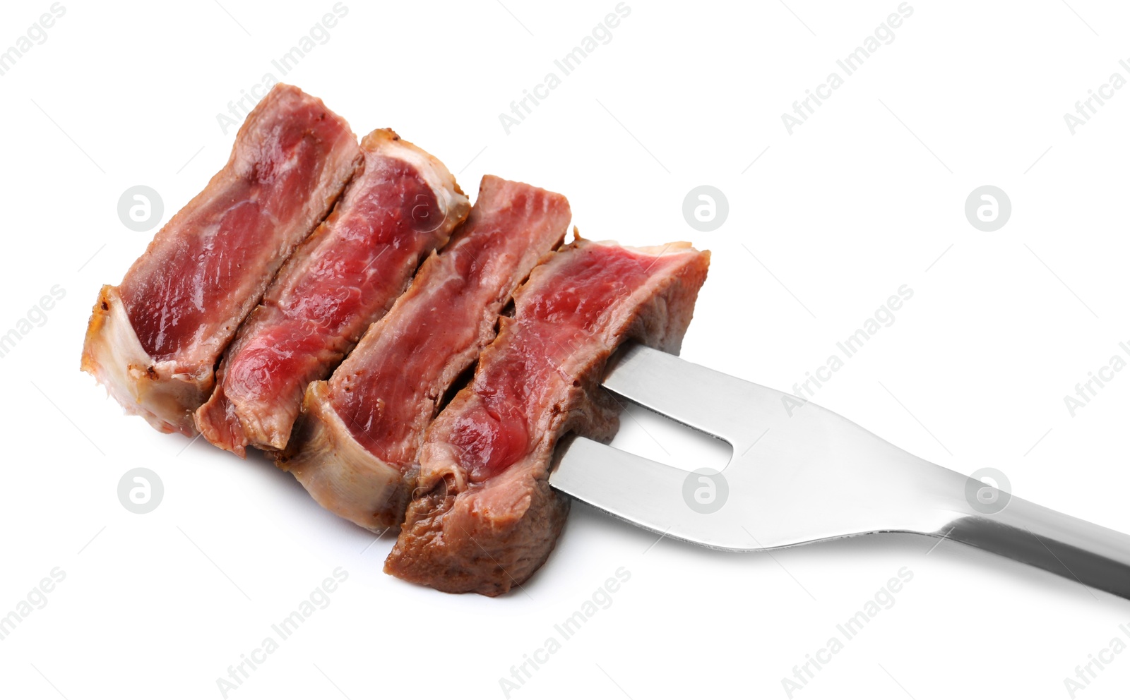 Photo of Carving fork with pieces of delicious beef meat isolated on white