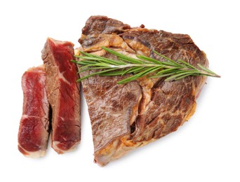 Photo of Pieces of delicious beef meat and rosemary isolated on white, top view