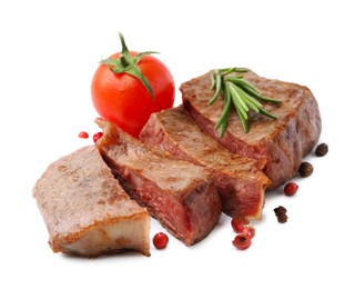 Photo of Pieces of delicious beef meat, spices and tomato isolated on white