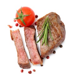 Photo of Pieces of delicious beef meat, spices and tomato isolated on white, top view