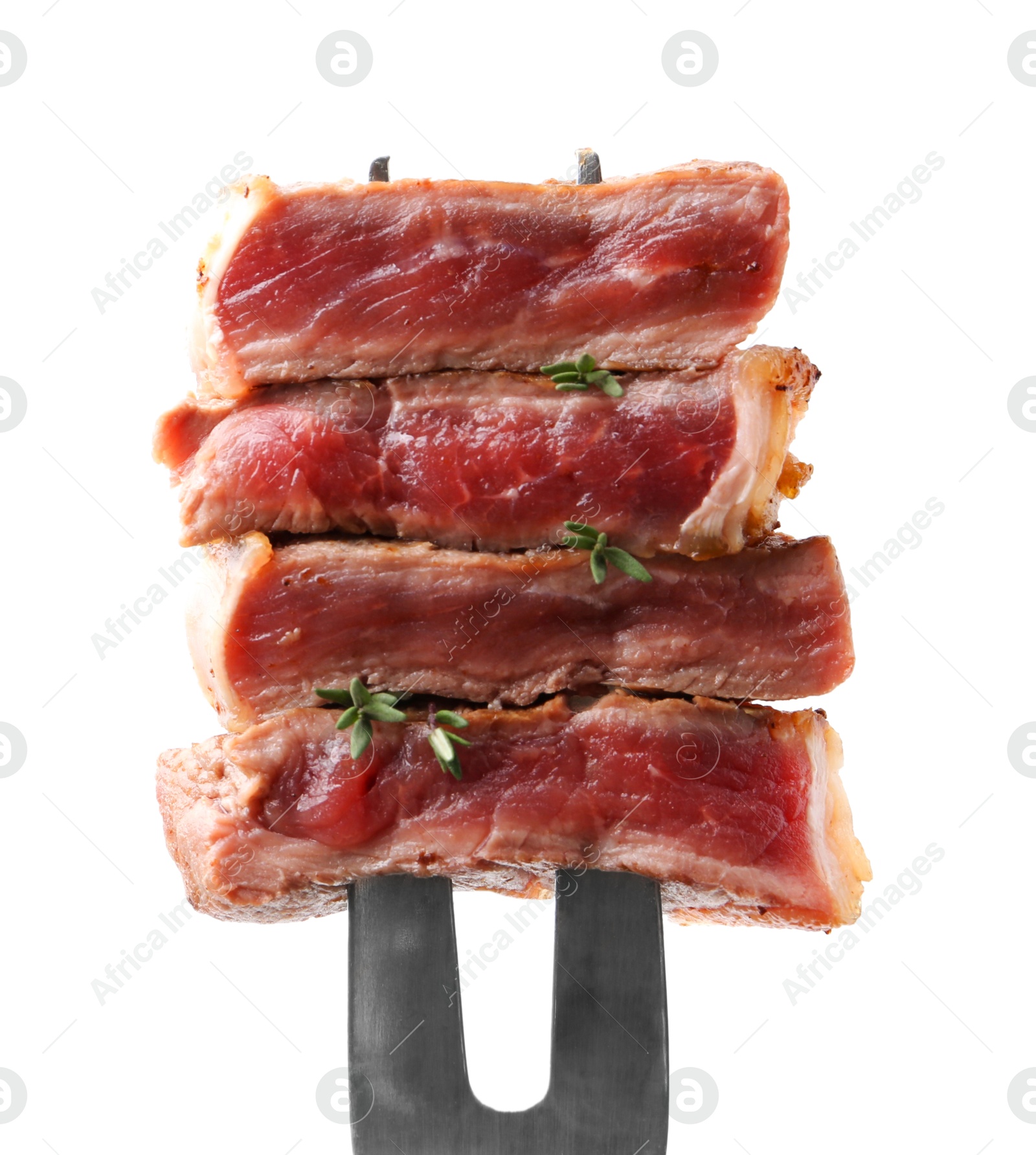 Photo of Carving fork with pieces of delicious beef meat and thyme isolated on white