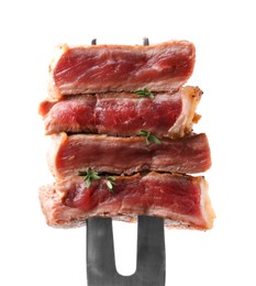 Photo of Carving fork with pieces of delicious beef meat and thyme isolated on white