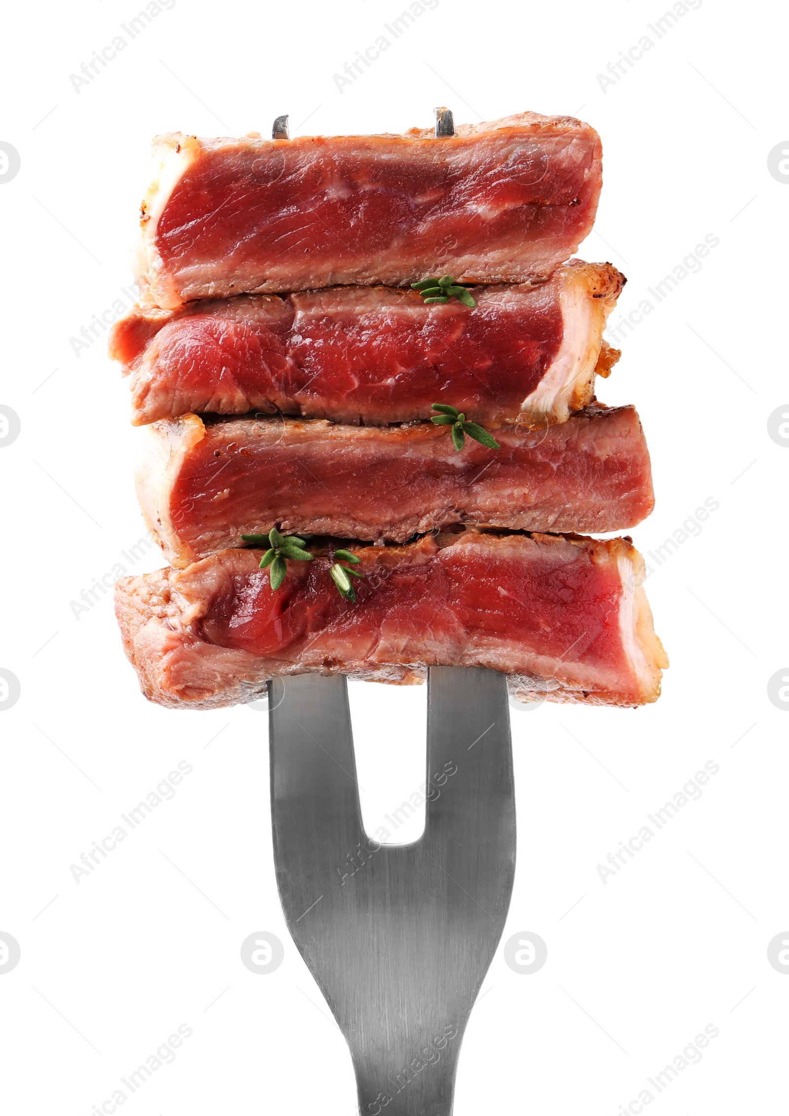 Photo of Carving fork with pieces of delicious beef meat and thyme isolated on white