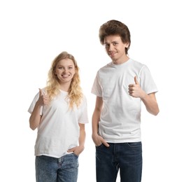 Photo of Young woman and man wearing blank t-shirts on white background. Mockup for design