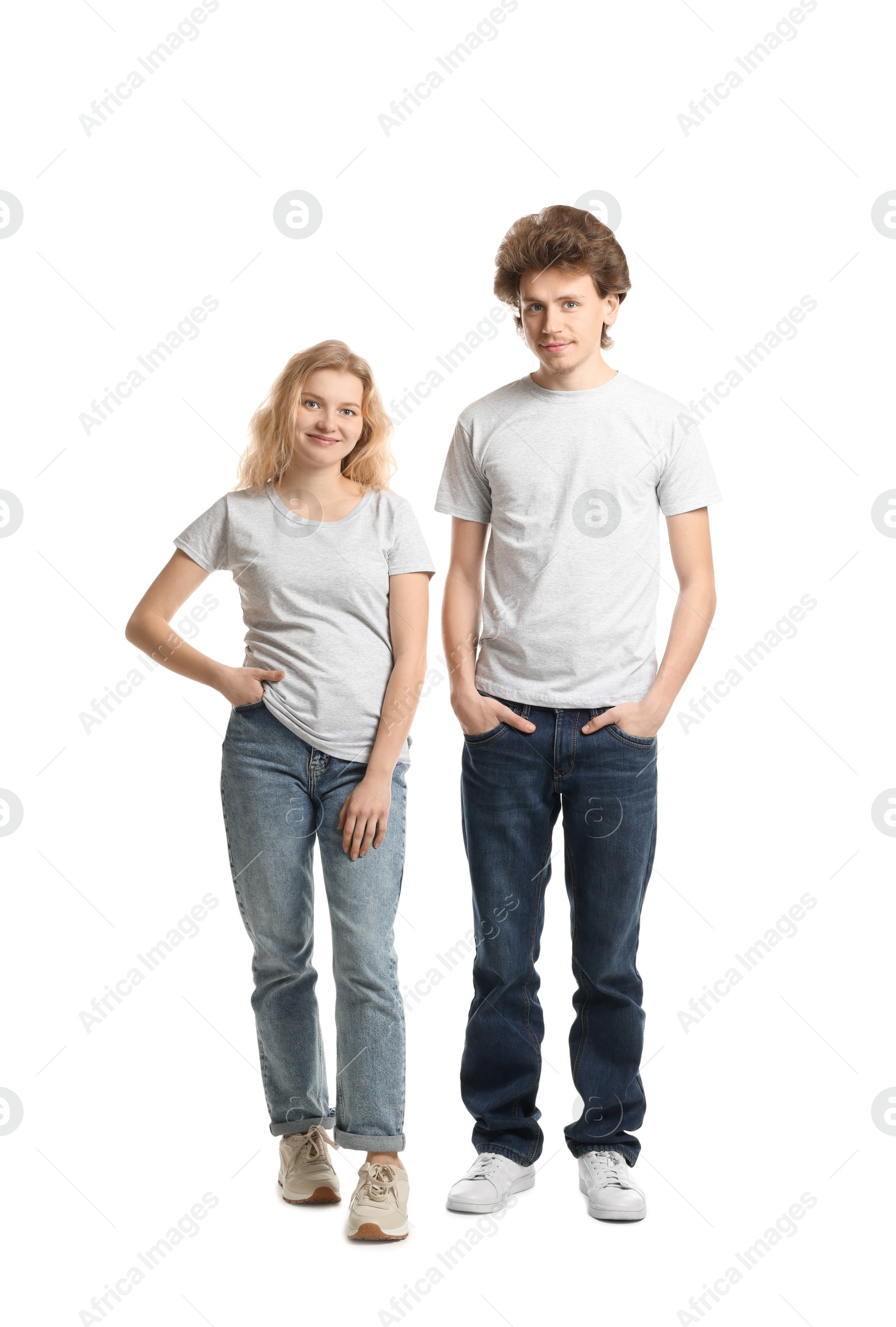 Photo of Young woman and man wearing blank t-shirts on white background. Mockup for design