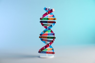 Photo of DNA structure model on light blue background