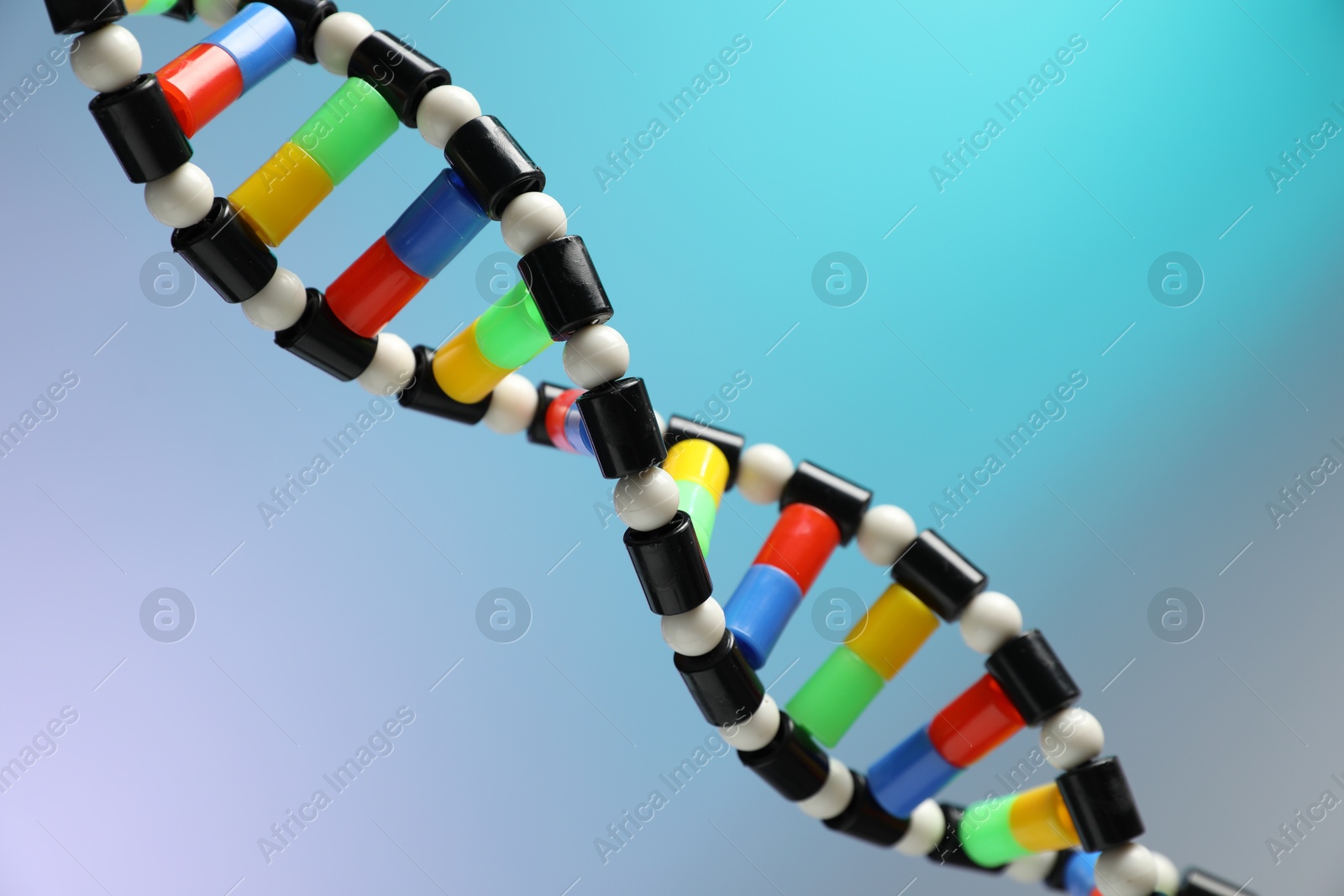 Photo of DNA structure model on color background, closeup