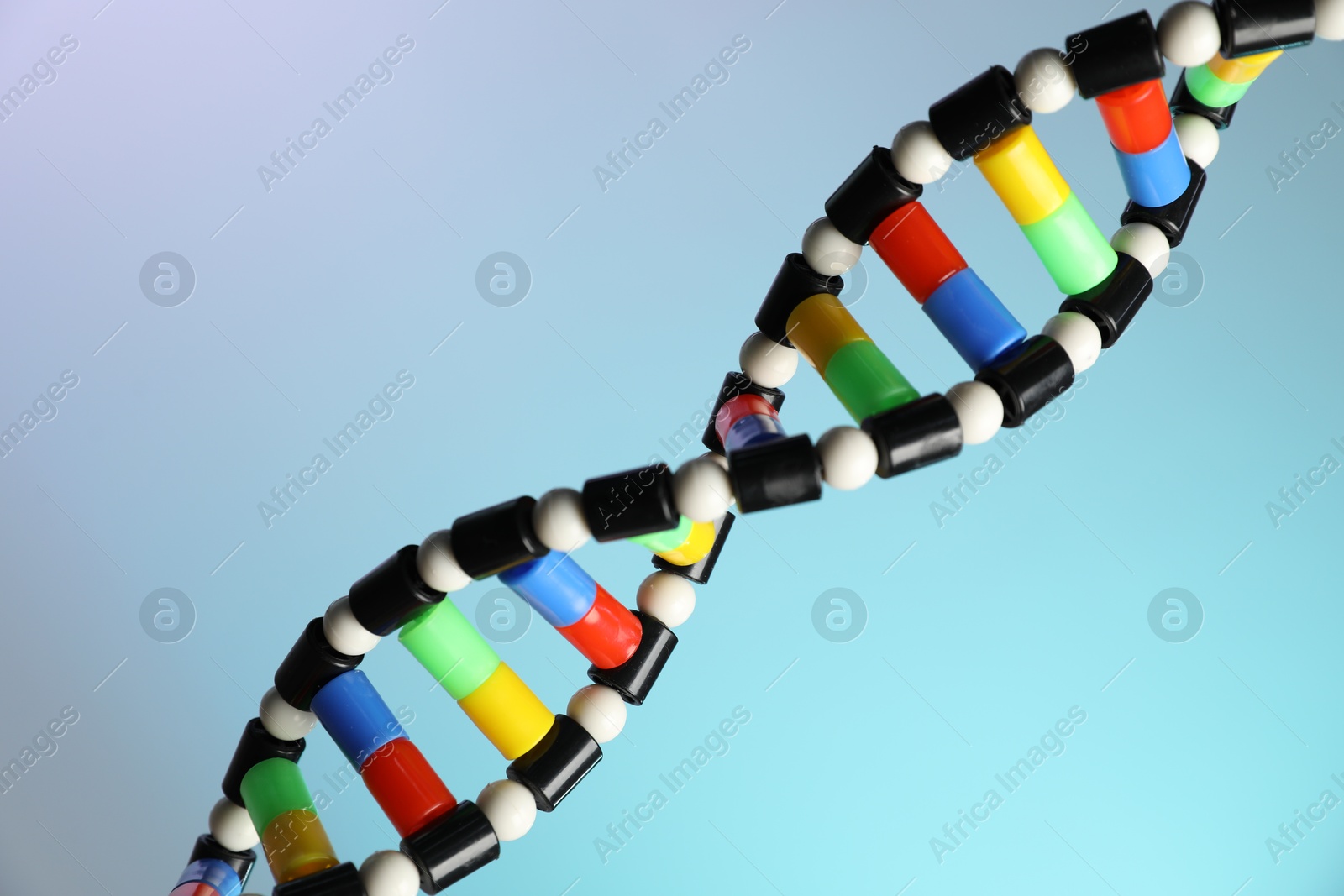 Photo of DNA structure model on color background, closeup