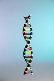 Photo of One DNA structure model on color background