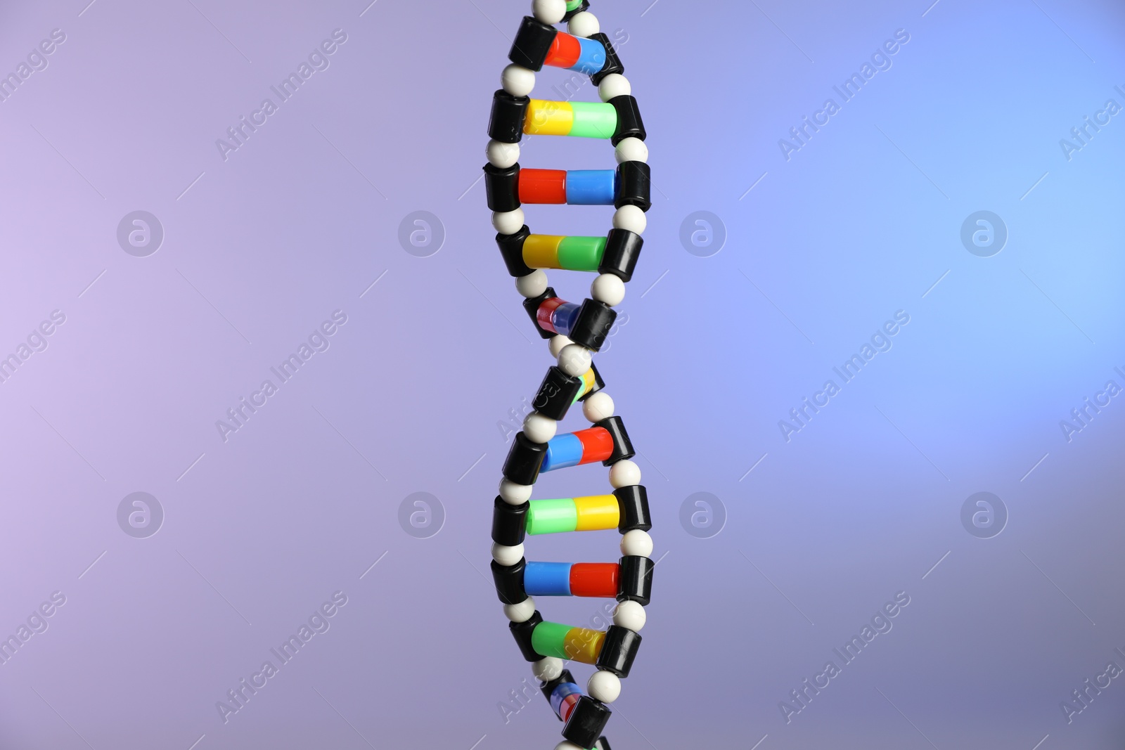 Photo of DNA structure model on color background, closeup