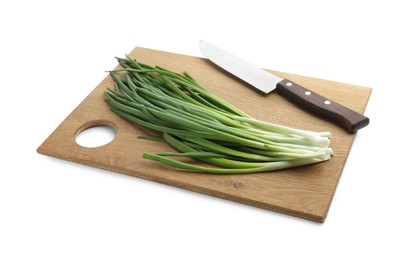 Photo of Wooden cutting board with green onions and knife isolated on white