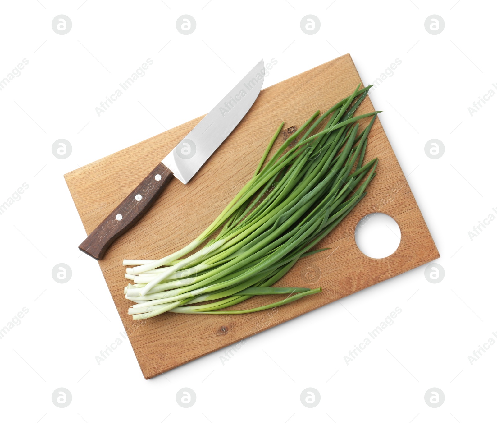 Photo of Wooden cutting board with green onions and knife isolated on white, top view