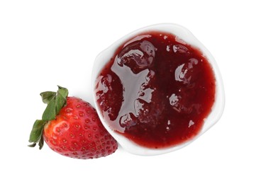 Photo of Tasty strawberry sauce in bowl and fresh berry isolated on white, top view