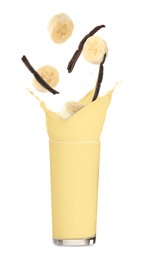 Image of Banana vanilla milkshake, pods and pieces of fresh fruit on white background