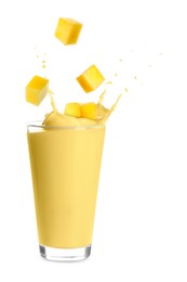 Image of Mango milkshake and pieces of fresh fruit on white background