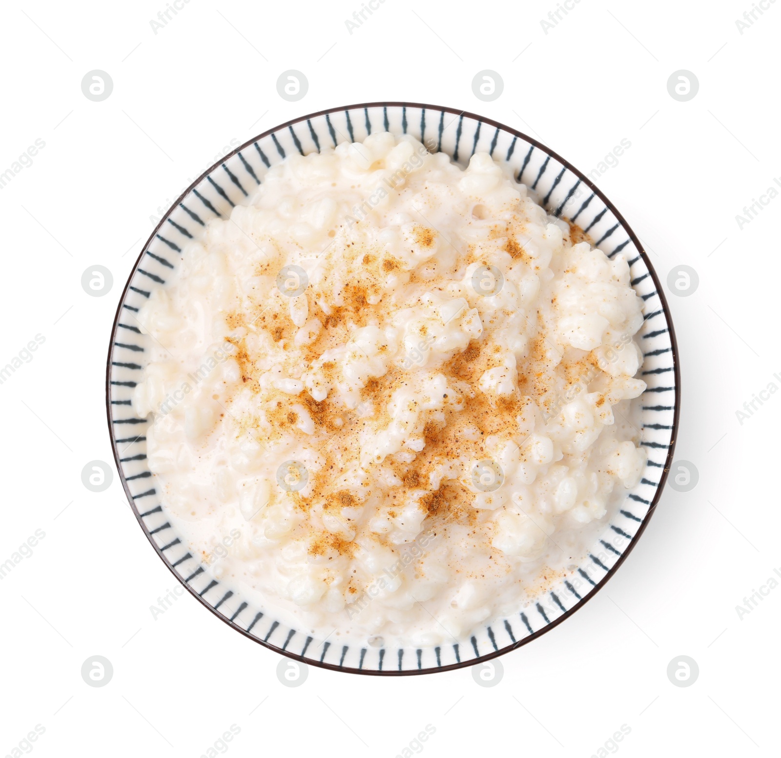 Photo of Tasty rice pudding with cinnamon isolated on white, top view